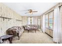Cozy living room with neutral carpet, vintage wallpaper, and ample natural light from the large window at 416 Donna Ave, Gastonia, NC 28052