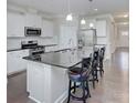 Modern kitchen featuring an island with dark countertops, stainless steel appliances, and white cabinetry at 4333 Legacy Dr, Denver, NC 28037