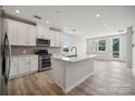 Bright, modern kitchen with stainless steel appliances, island, and light wood flooring at 4455 Reed Creek Dr # 101, Sherrills Ford, NC 28673