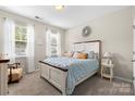 Cozy bedroom with natural light, plush carpeting, and tasteful beach-themed decor at 5059 Fenwick Ct, Lancaster, SC 29720
