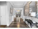 Inviting entryway features wood flooring, decorative wallpaper and molding, plus views into the living area at 5059 Fenwick Ct, Lancaster, SC 29720