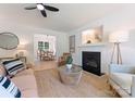 Bright living room featuring a fireplace, neutral decor and a ceiling fan at 5229 Tarrywood Ln, Charlotte, NC 28205