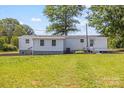 Spacious backyard with lush green grass surrounding the charming single story home at 5354 Sherrills Ford Rd, Catawba, NC 28609