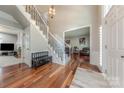 Grand foyer featuring hardwood floors, staircase with wrought iron spindles, and ample natural light at 5707 Fairvista Dr, Charlotte, NC 28269