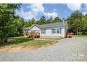 Single story home with gravel driveway and a small rear deck at 5720 Enochville School Rd, Kannapolis, NC 28081