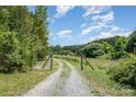 Gated gravel driveway leading to property at 5720 Enochville School Rd, Kannapolis, NC 28081