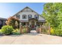 Inviting front entrance with wooden bridge, lush landscaping and a charming covered porch at 5888 Wood Duck Way, Catawba, NC 28609