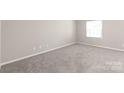 Bright bedroom with neutral carpet, providing a serene space ready for personalization at 5949 Quail Hollow Rd # E, Charlotte, NC 28210