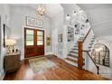 Inviting foyer with hardwood floors, a staircase, and double wood doors, offering a warm welcome at 7221 High Point Ct, Charlotte, NC 28278