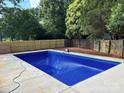 Backyard pool with new concrete and wooden fence at 756 Logan St, Mooresville, NC 28115