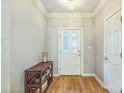Entryway features hardwood floors and white trim with a wooden shelf to the side at 9137 Brightleaf Pl, Charlotte, NC 28269