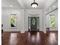Elegant foyer featuring hardwood floors, a decorative front door, and abundant natural light from large windows at 9261 Marvin School Rd, Marvin, NC 28173