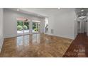 Spacious living room featuring tile flooring, access to the backyard pool, and a staircase leading to the upper level at 9261 Marvin School Rd, Marvin, NC 28173