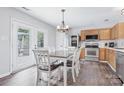 Inviting kitchen with stainless steel appliances, light wood cabinets, and a dining table with seating for six at 1003 Snake River Ct, Monroe, NC 28110