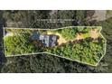 Aerial view of a property, surrounded by lush greenery and mature trees with a defined property line at 1004 E Sandy Ridge Rd, Monroe, NC 28112