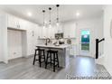 Bright kitchen with white cabinetry, stainless steel appliances, and a functional center island with bar stools at 10339 Lakeshore Dr # 85, Lancaster, SC 29720