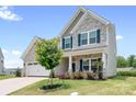 Charming two-story home with stone accents, blue shutters, and a well-manicured lawn at 106 Tuppy Ct, Statesville, NC 28625
