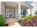 Inviting front porch with stone pillars, seating area, and well-maintained landscaping at 106 Tuppy Ct, Statesville, NC 28625