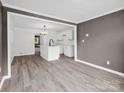 Open layout showcasing the waterproof floors, gray walls, and white kitchen with island at 111 Wolfe Rd, Shelby, NC 28152