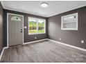 Cozy living room featuring grey walls, a gray door and trim, and waterproof flooring at 111 Wolfe Rd, Shelby, NC 28152