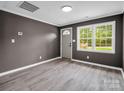 Inviting living room featuring modern gray walls, white trim and waterproof gray flooring at 111 Wolfe Rd, Shelby, NC 28152