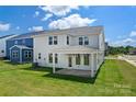 Spacious backyard with a covered patio, lush green lawn, and serene views of the surrounding landscape at 12009 Grinstead Ln # 303, Charlotte, NC 28278