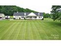 Charming home featuring black shutters, manicured landscaping, and a spacious lawn at 1238 Shinnville Rd, Cleveland, NC 27013