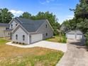 An aerial view showcases a home with a detached two-car garage and lengthy driveway at 126 Aurora Blvd, Matthews, NC 28105