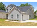 View of home showing attached two-car garage and paved driveway at 126 Aurora Blvd, Matthews, NC 28105