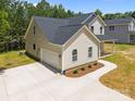 New construction home boasts a large driveway leading to a two-car garage at 130 Aurora Blvd, Matthews, NC 28105
