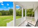 Inviting front porch featuring a classic swing, offering a relaxing outdoor space with views of the lush greenery at 132 Witherspoon Ln, Statesville, NC 28677