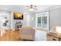 Cozy living room with hardwood floors, neutral paint, large window, and comfortable seating at 132 Witherspoon Ln, Statesville, NC 28677