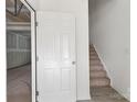 Bright entryway showcasing a staircase and a door leading to an unfinished basement at 15034 Scoter St, Charlotte, NC 28262