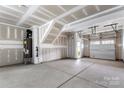 Spacious unfinished garage with a concrete floor, perfect for storage or future customization at 15034 Scoter St, Charlotte, NC 28262