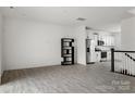 Bright living room featuring an open-concept layout with modern flooring and kitchen view at 15034 Scoter St, Charlotte, NC 28262