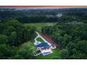 Expansive home with a pool and manicured grounds nestled in a lush, green landscape at 15037 June Washam Rd, Davidson, NC 28036