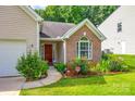 Inviting front entrance with brick accents, lush landscaping, and a welcoming walkway at 1520 Deer Forest Dr, Fort Mill, SC 29707