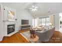 Bright living room with a fireplace, high ceilings, and large windows for ample natural light at 1520 Deer Forest Dr, Fort Mill, SC 29707