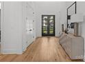 Bright entryway features hardwood floors and views of the front yard through glass paned double doors at 2121 Laburnum Ave, Charlotte, NC 28205