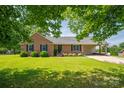 Lovely single-story brick home with a covered carport and a well-manicured lawn, shaded by mature trees at 233 Reliance Rd, Kings Mountain, NC 28086