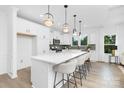 Modern kitchen featuring white cabinets, a large island with seating, and stainless steel appliances at 24578 Blue Heron Cir # 407, Lancaster, SC 29720