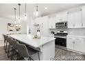 Kitchen showcases white cabinets, stainless steel appliances, and a spacious island with seating at 24578 Blue Heron Cir # 407, Lancaster, SC 29720