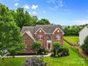 Striking brick home with a well-manicured front yard, tasteful landscaping, and inviting curb appeal at 3213 Strawberry Rd, Matthews, NC 28104