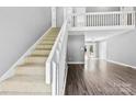 Bright entryway featuring hardwood floors, staircase with white railing, and open floor plan at 328 Pamela St, Gastonia, NC 28054