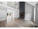 Open-concept living room with modern floors, a cozy fireplace, and bright windows that lead to a deck at 328 Pamela St, Gastonia, NC 28054