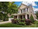 Beautifully landscaped yard complements this home with stone accents and a welcoming front porch at 3351 Streamside Dr, Davidson, NC 28036