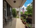 Cozy front porch with seating, perfect for enjoying the landscaped garden and neighborhood views at 3351 Streamside Dr, Davidson, NC 28036