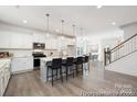 Spacious kitchen featuring a large island with bar stool seating, seamlessly flowing into the dining area at 36140 Greg Norman Dr # 1003, Lancaster, SC 29720