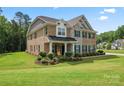 Beautiful two-story home with brick and stone facade, well-manicured lawn, and lush landscaping at 4008 Pinot Way, Fort Mill, SC 29707