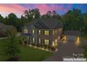 Stunning two-story brick home boasts professionally landscaped yard and separate three car garage at 4008 Pinot Way, Fort Mill, SC 29707